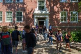 Students moving in and out of a campus building